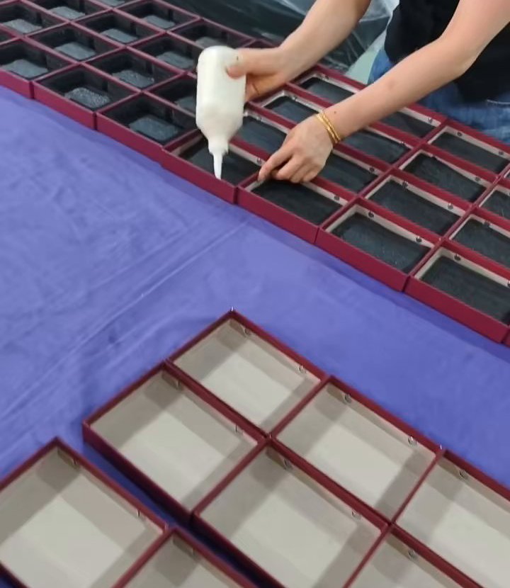Adhesive applied during box insert fitting at the Guangzhou manufacturing partner