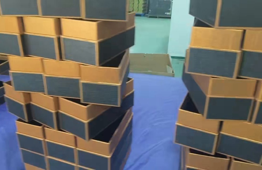 Dark and orange rigid box bodies at the Guangzhou manufacturing partner workshop