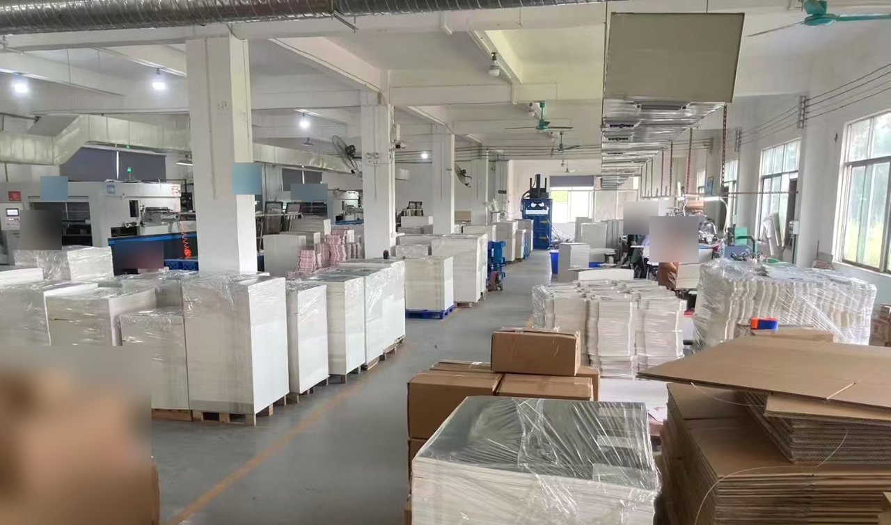 Wrapped paper stacks and machinery inside the Guangzhou manufacturing partner workshop