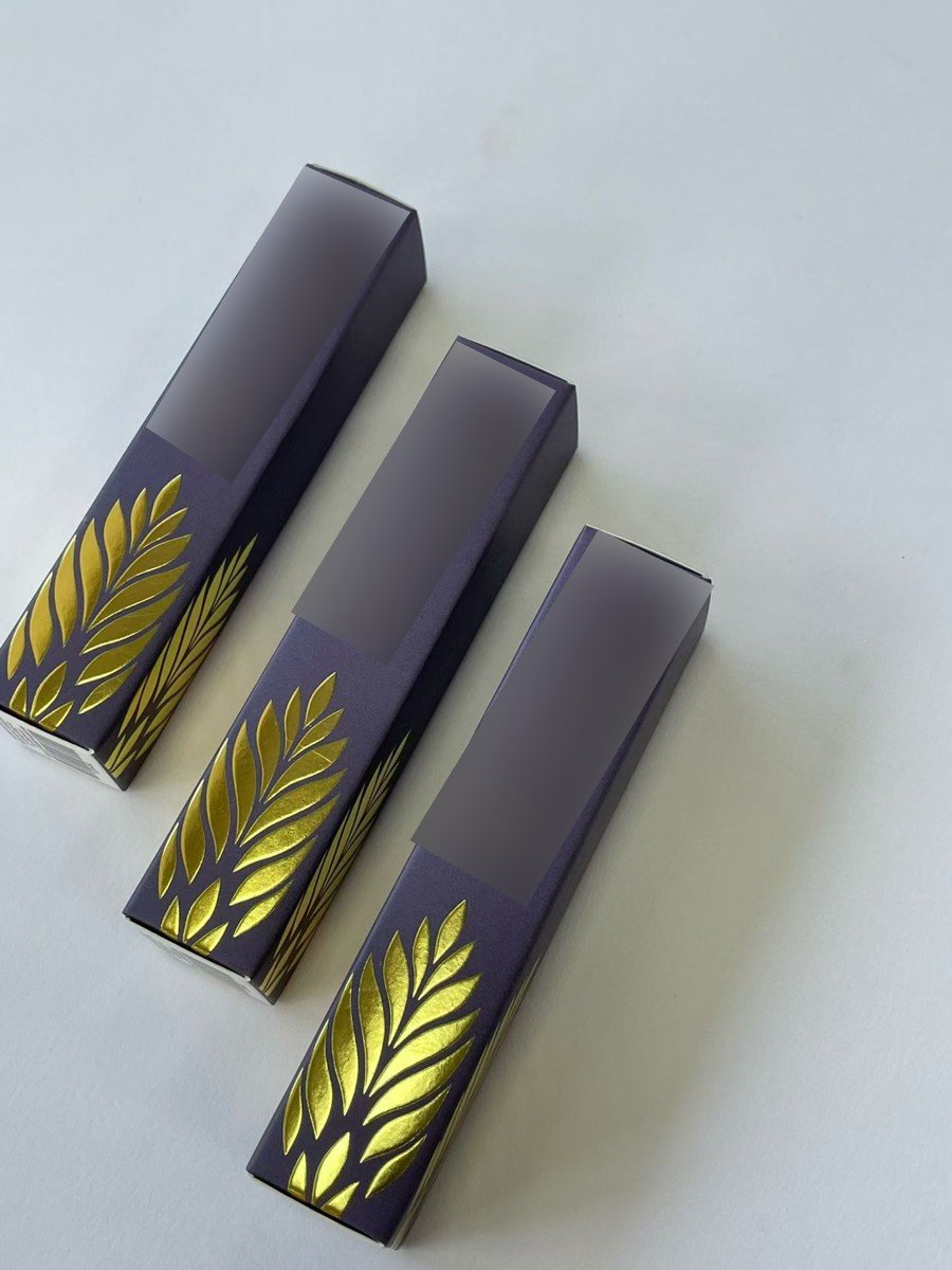 Purple folding carton samples with gold-coloured leaf decoration